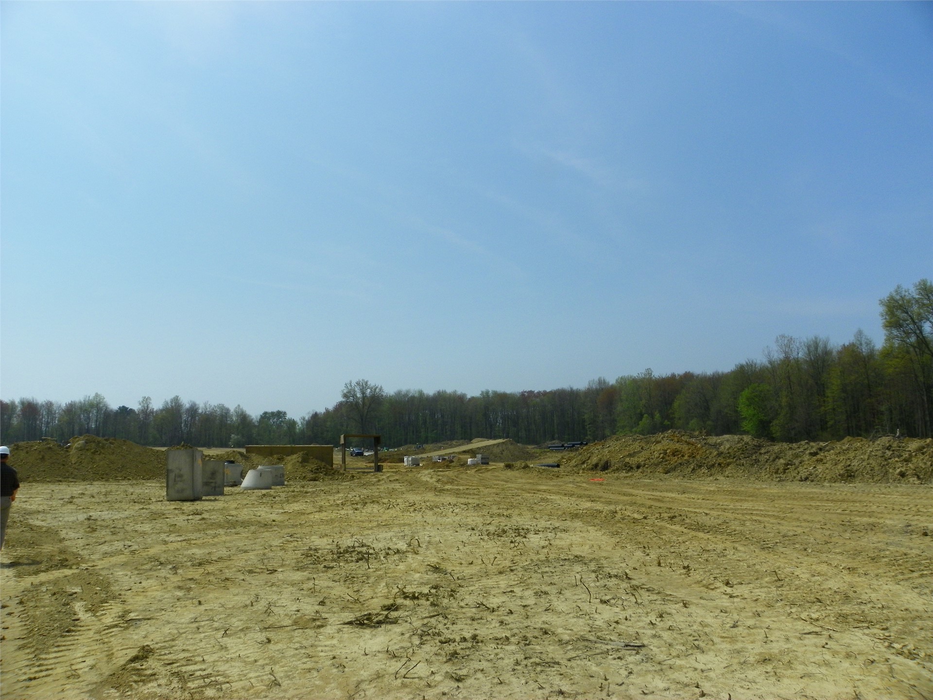 Photo of stadium site (dirt ramp is fill topsoil)—picture taken from parking lot