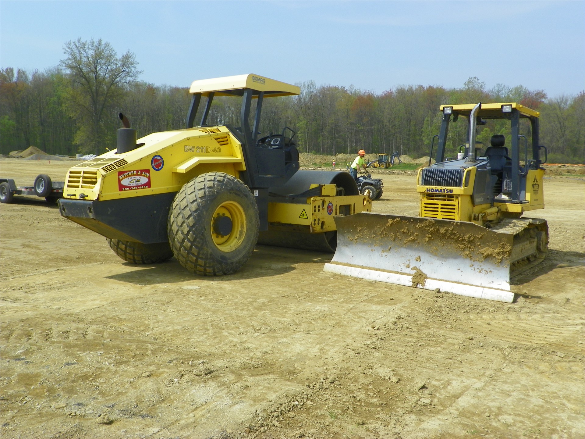 Earth mover and roller to flatten pads and roll out field