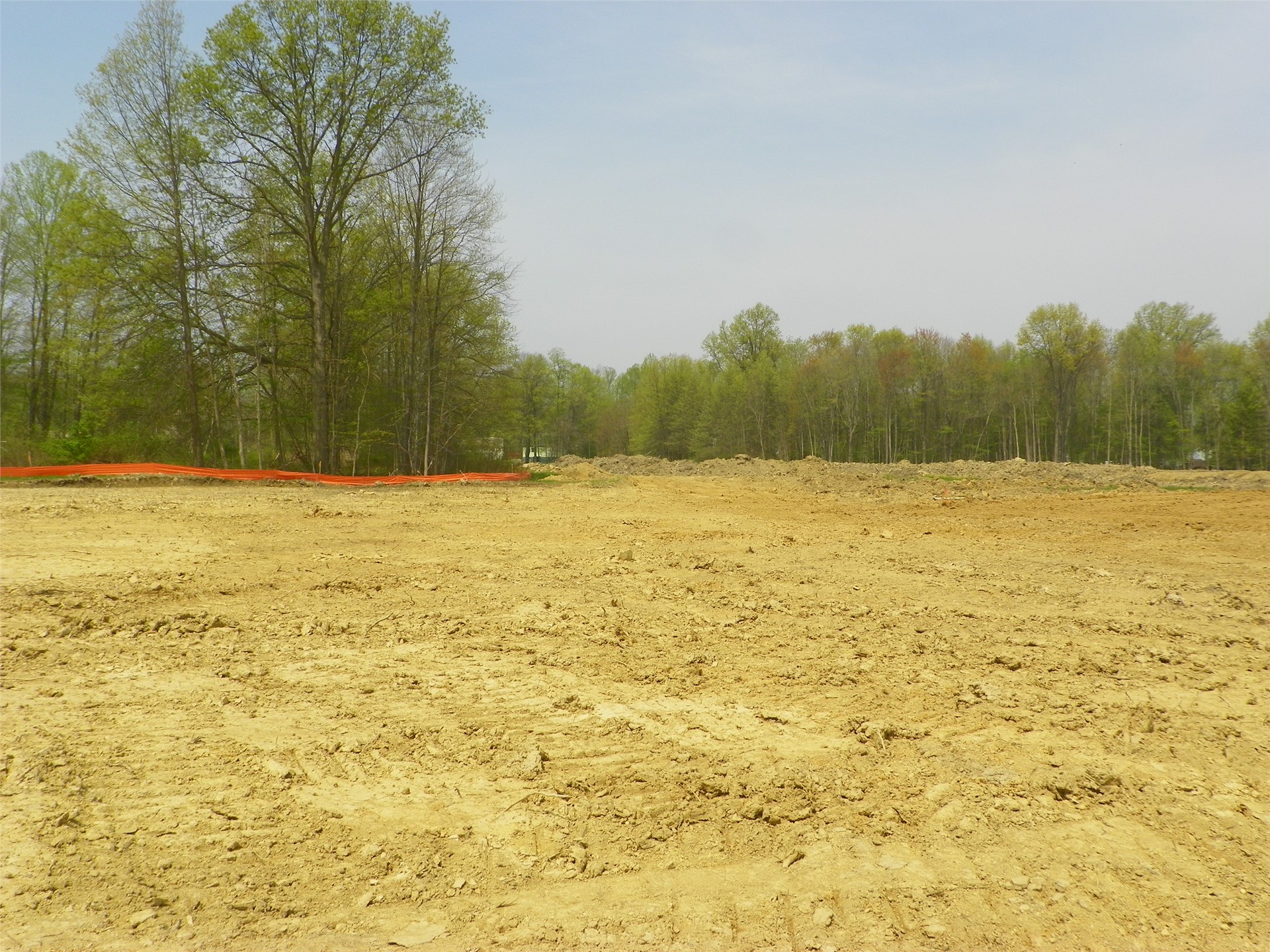 Softball field will be constructed behind trees to left, soccer field in center/right side of photo