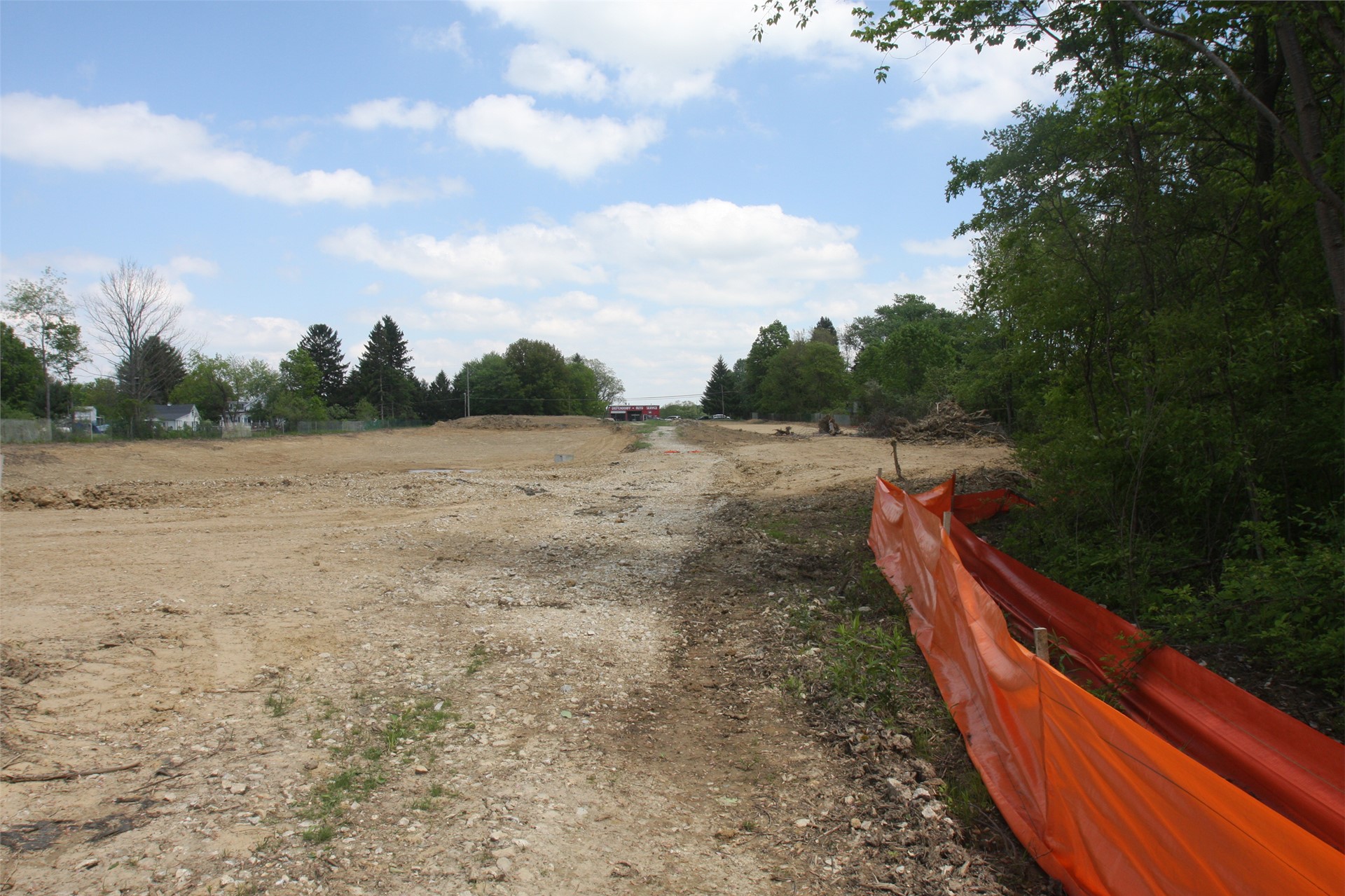 Zoomed out image of retention basin (left) and main drive way (right) with Diefendorff Auto Service 