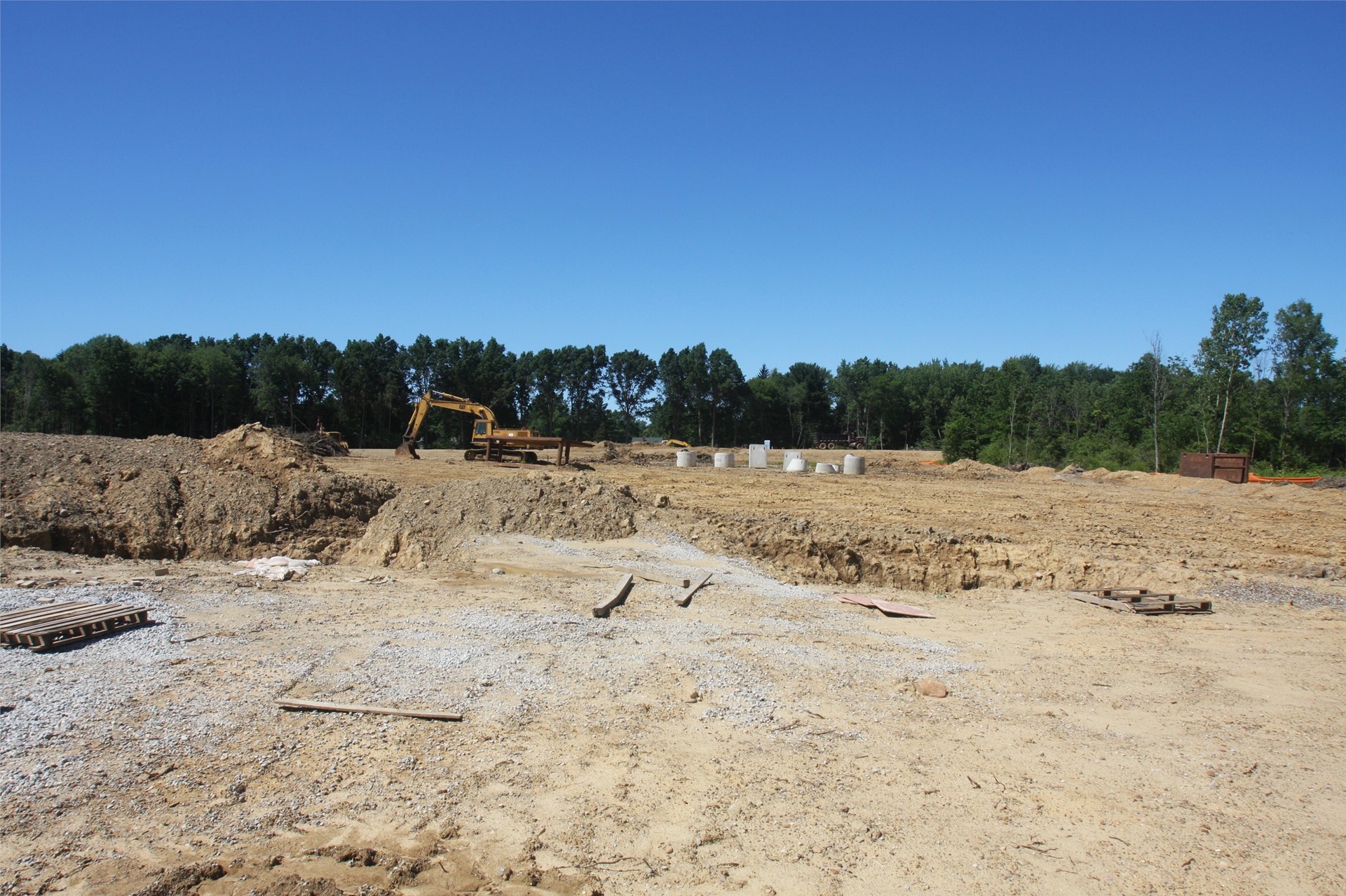 View of parking lot area (High School will sit along tree line, beyond construction vehicle)