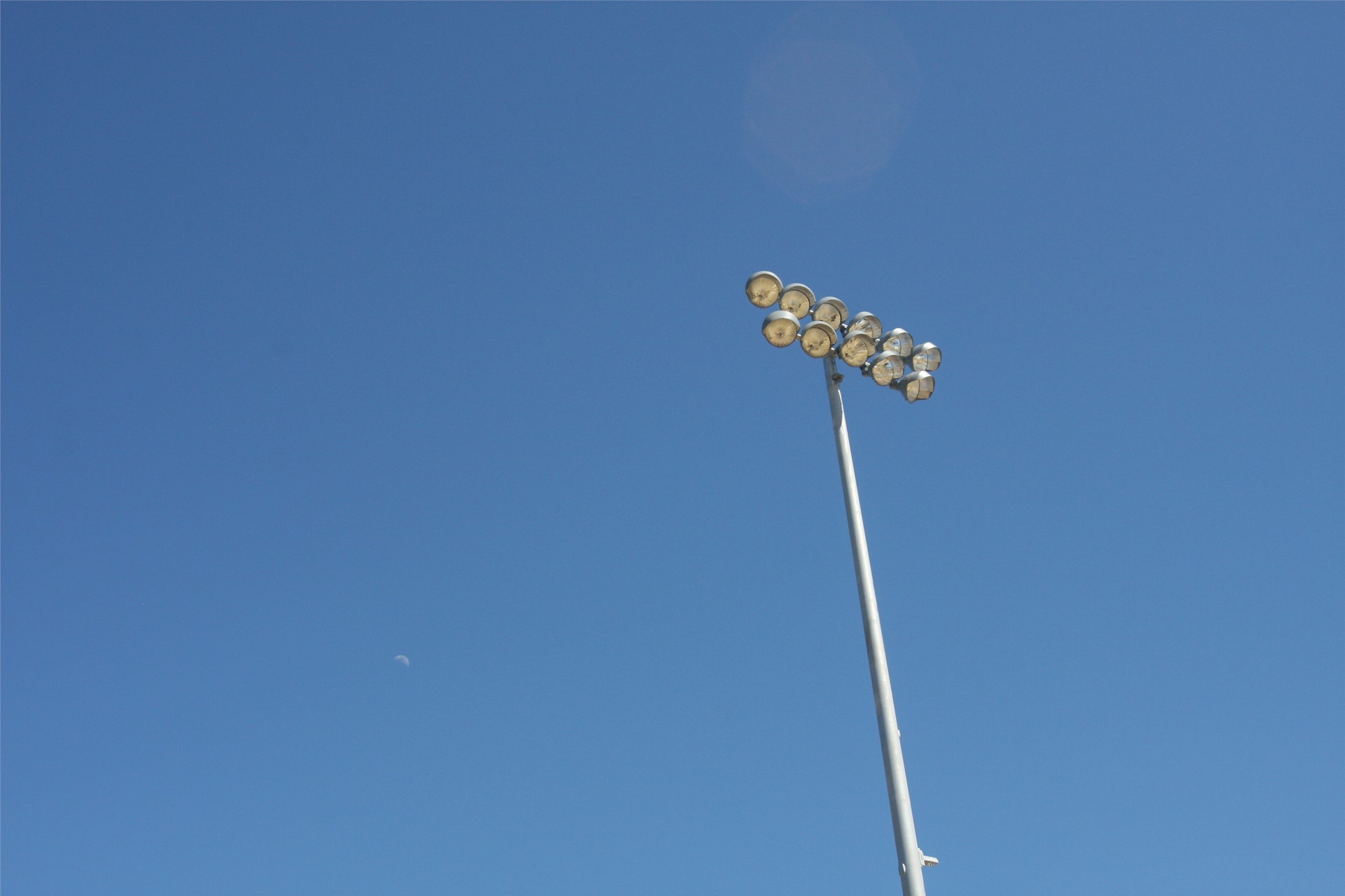 Stadium lights above visitor side (moon to left of light pole)
