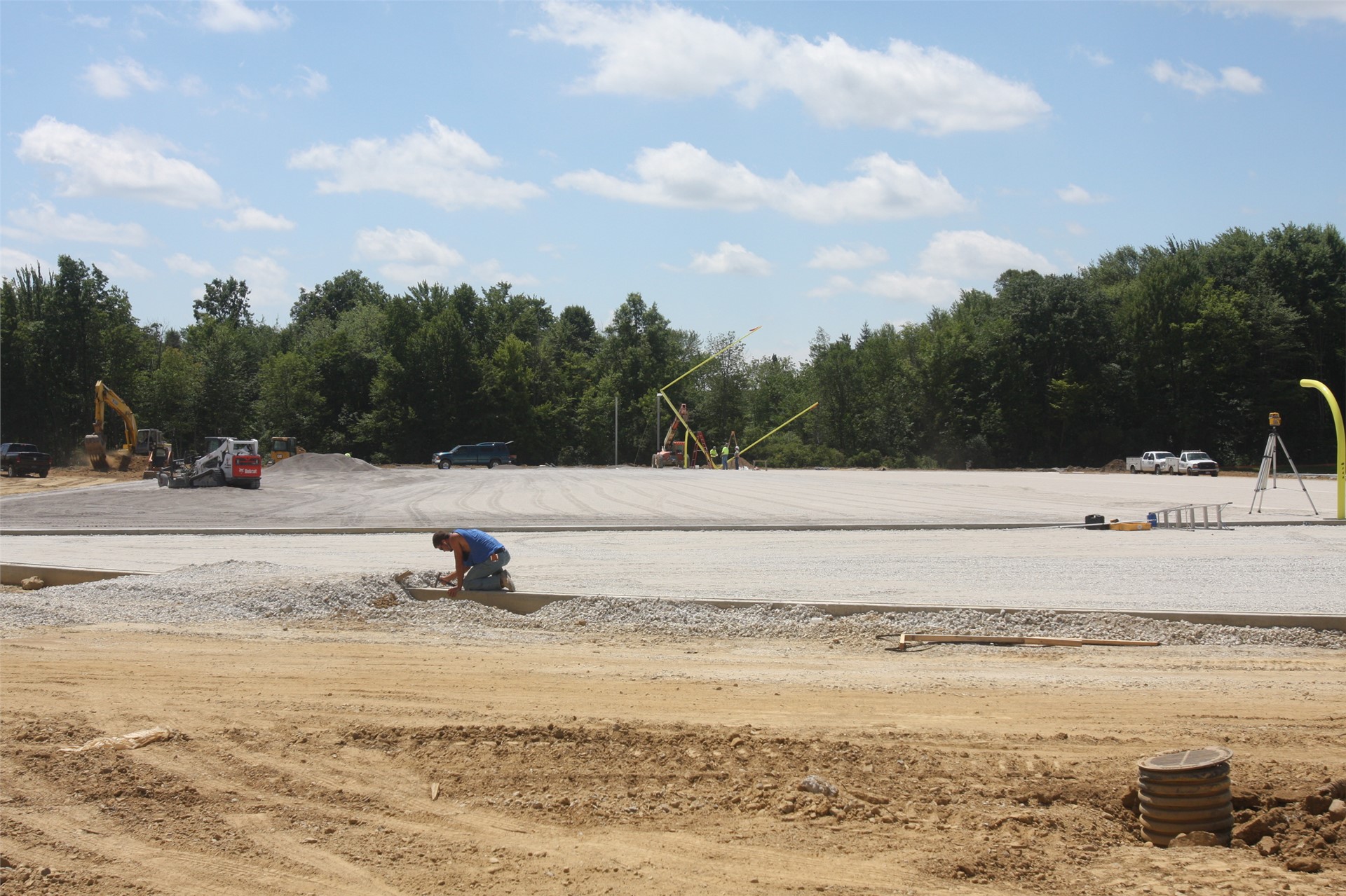The field is being leveled and prepared for the turf installation; the goal posts are being installe