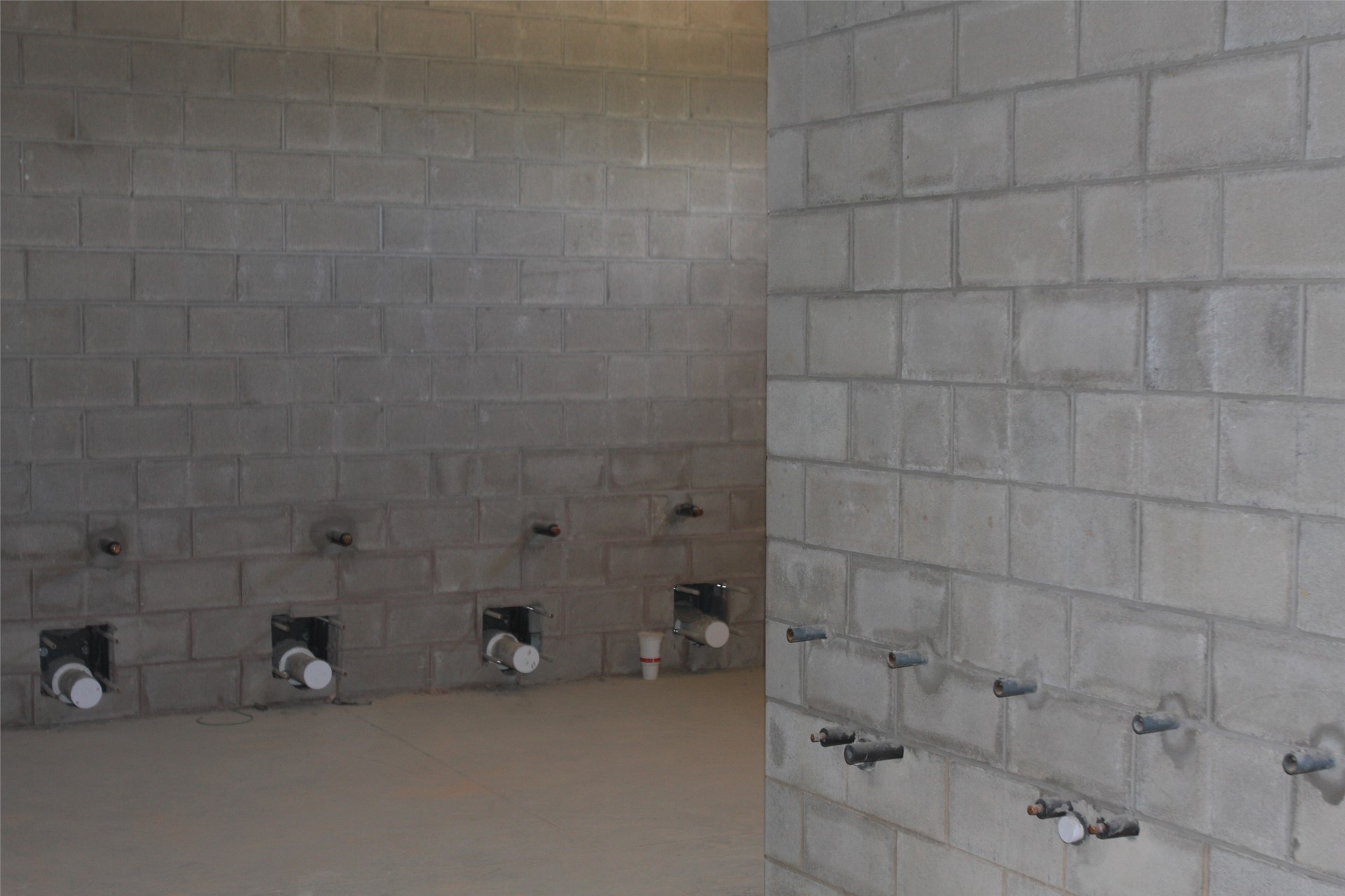 Plumbing is ready for toilets and sinks in the women’s restroom