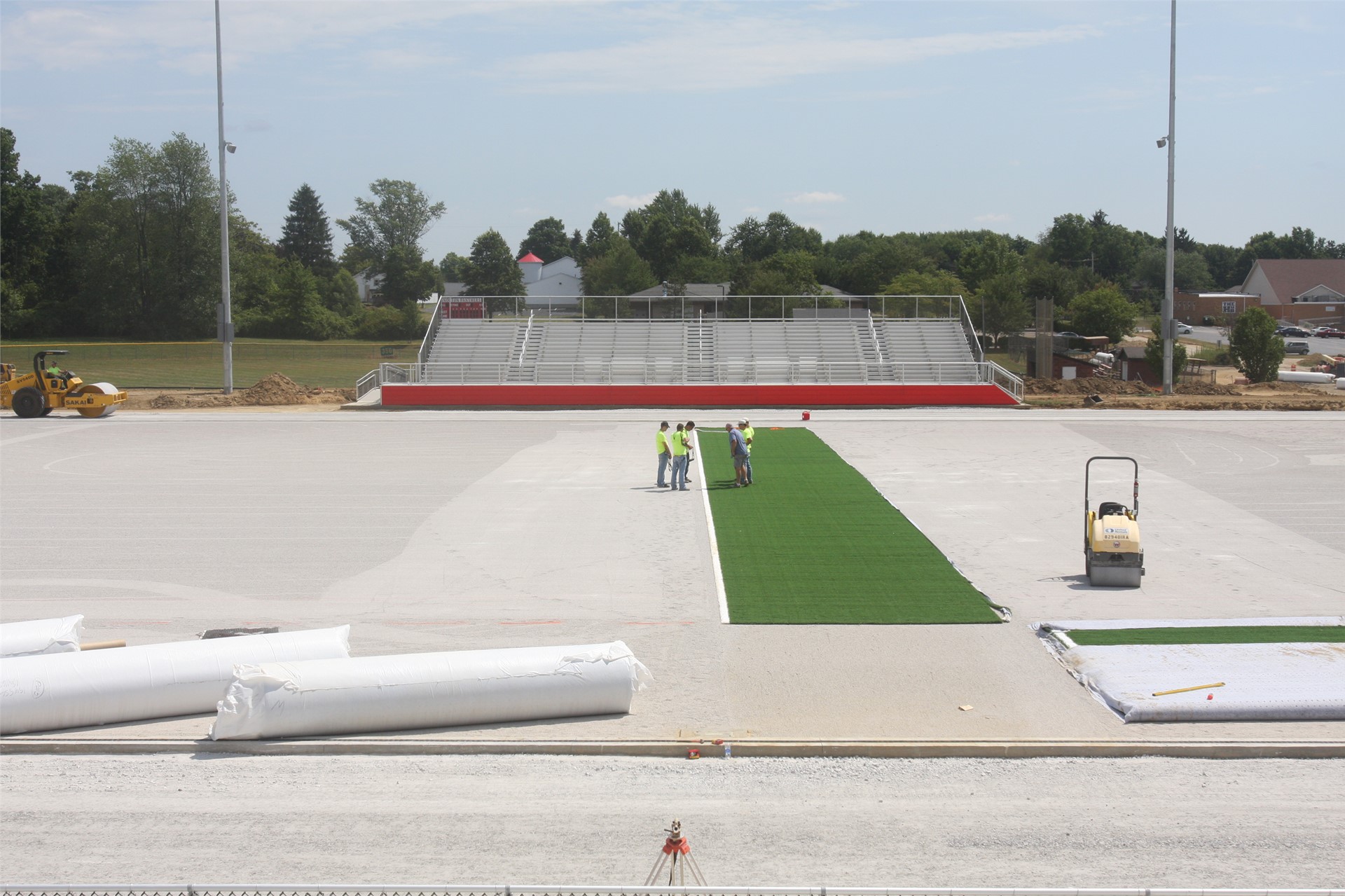 The first roll of turf being installed on the field