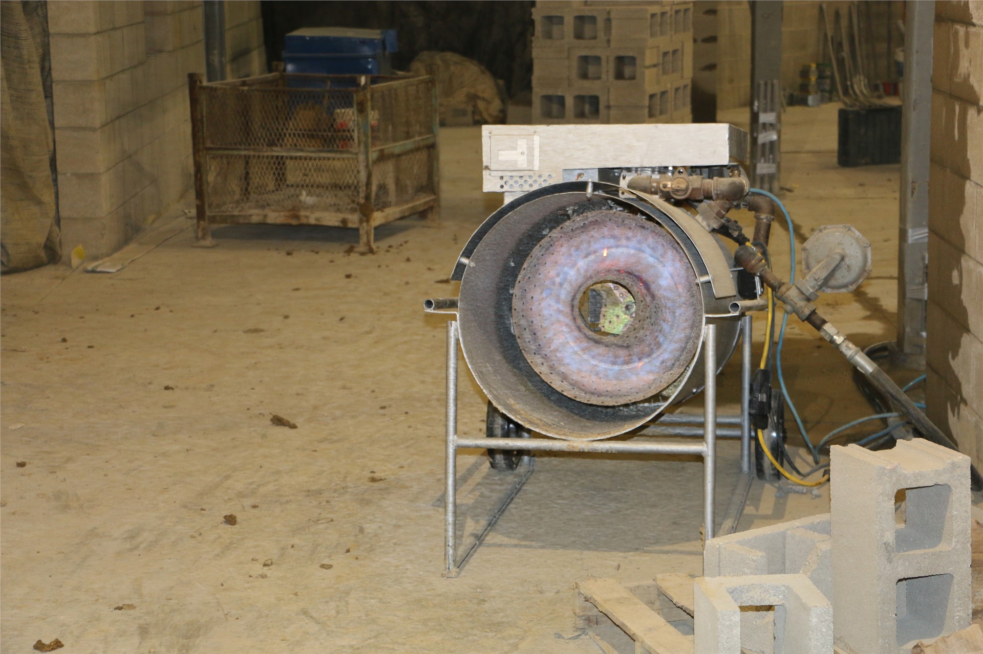 One of many heaters being used to warm up parts of the building for workers and materials to work 	i