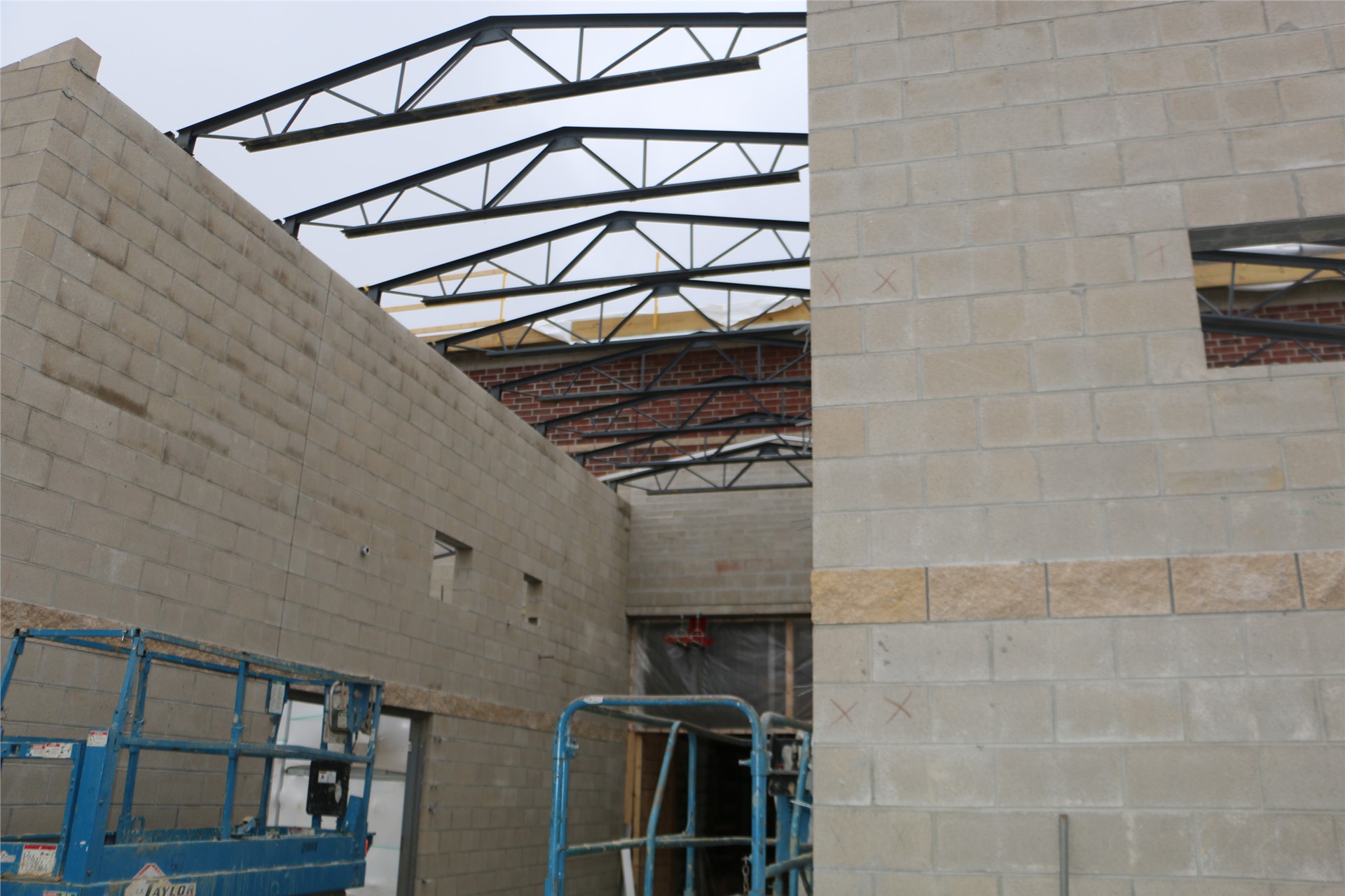 Exterior brick is in place above main corridor connecting the central rotunda to the academic wing