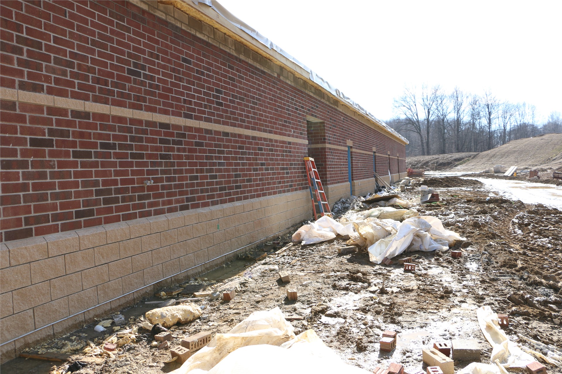 Exterior brick in place on the back of the locker rooms (behind gymnasium)