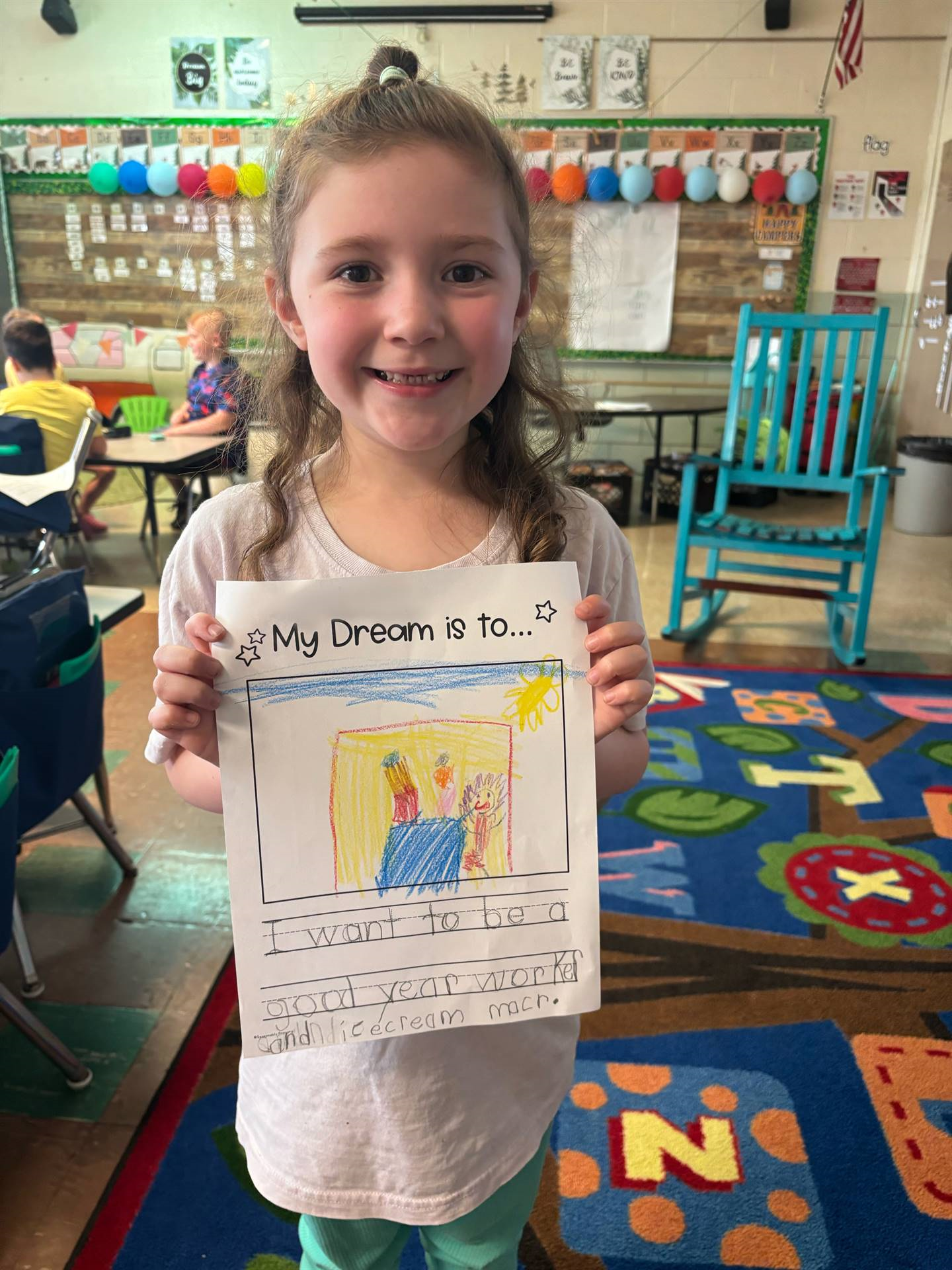 Student holding up her work with her career dream.
